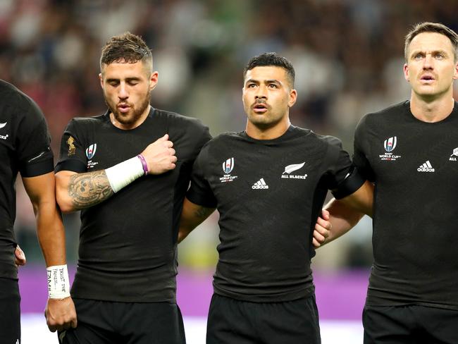 OITA, JAPAN - OCTOBER 02: (L to R) TJ Perenara, Richie Mo'unga and Ben Smith of New Zealand line up for the national anthem prior to the Rugby World Cup 2019 Group B game between New Zealand and Canada at Oita Stadium on October 02, 2019 in Oita, Japan. (Photo by Hannah Peters/Getty Images)