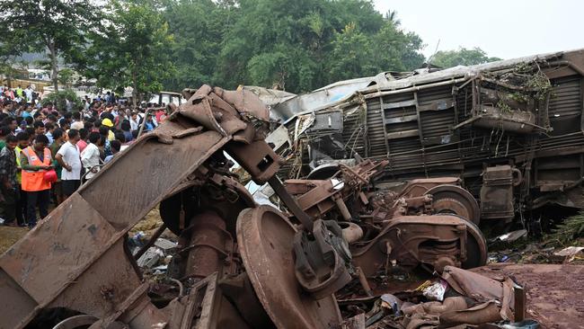 Rescue teams and onlookers next to the wreckage near Balasore. Picture: AFP