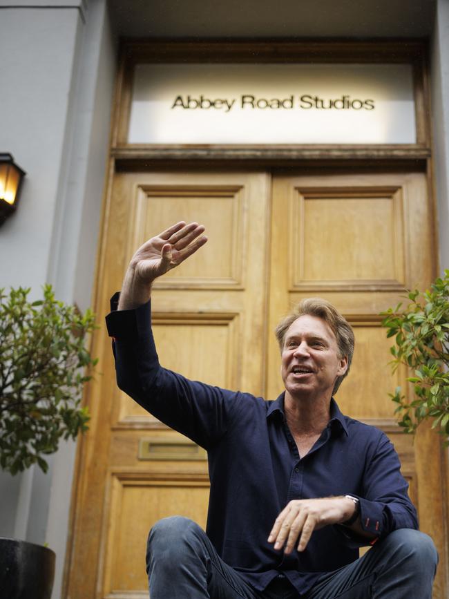 Martin waves at tourists who spot him during a photo shoot on the steps of Abbey Road. Picture: Jamie Lorriman