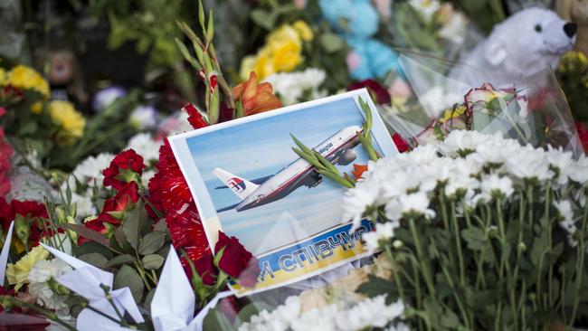 Flowers, candles and other tributes are left in front of the Netherlands Embassy in memory of the victims of Malaysia Airlines flight MH17 on July 19, 2014 in Kiev, Ukraine