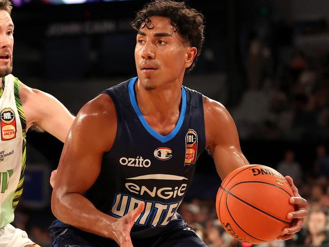 MELBOURNE, AUSTRALIA - FEBRUARY 03: Flynn Cameron of United handles the ball against Luke Rosendale of the Phoenix during the round 18 NBL match between Melbourne United and South East Melbourne Phoenix at John Cain Arena, on February 03, 2024, in Melbourne, Australia. (Photo by Kelly Defina/Getty Images)