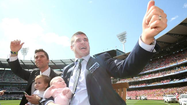 Brisbane Lions stars Simon Black, left, and Jonathan Brown do a lap of honour before the 2014 AFL grand final