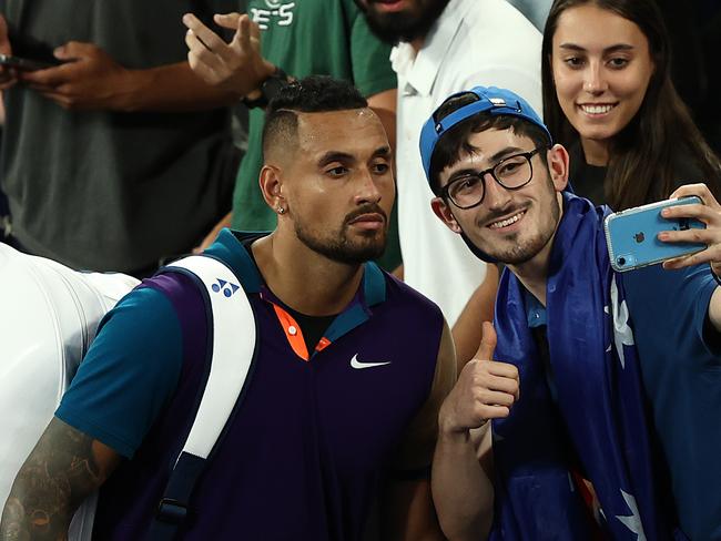 MELBOURNE, AUSTRALIA - FEBRUARY 10: Nick Kyrgios of Australia poses for selfies with fans after winning his Men's Singles second round match against Ugo Humbert of France during day three of the 2021 Australian Open at Melbourne Park on February 10, 2021 in Melbourne, Australia. (Photo by Mark Metcalfe/Getty Images)