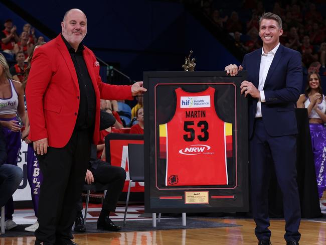 Craig Hutchison presents former Wildcats player framed jersey to club legend Damian Martin, in early 2024. Picture: Paul Kane/Getty Images