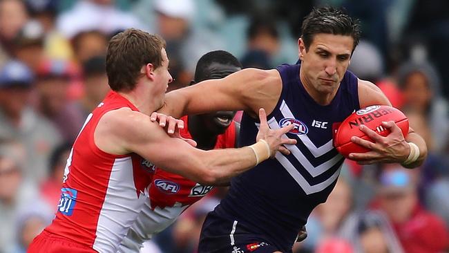 PERTH, AUSTRALIA — JULY 31: Matthew Pavlich of the Dockers attempts to break from a tackle during the round 19 AFL match between the Fremantle Dockers and the Sydney Swans at Domain Stadium on July 31, 2016 in Perth, Australia. (Photo by Paul Kane/Getty Images)