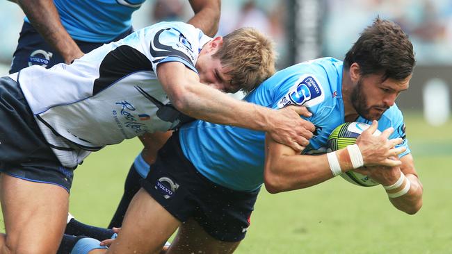 Waratahs centre Adam Ashley-Cooper is brought to ground.