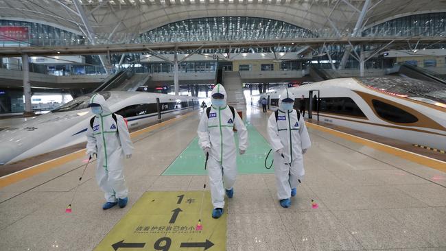 Firefighters disinfect the platform of Wuhan Railway Station in China as authorities prepared to end a two-month lockdown of coronavirus-hit Hubei province. Picture: AP