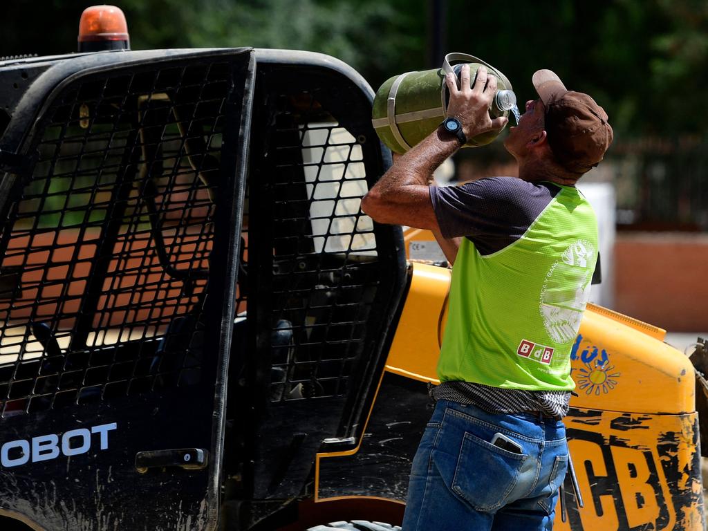 A worker drinks water while working in a street during a heatwave in Sevilla, in the southern Spanish region of Andalusia. Picture: AFP