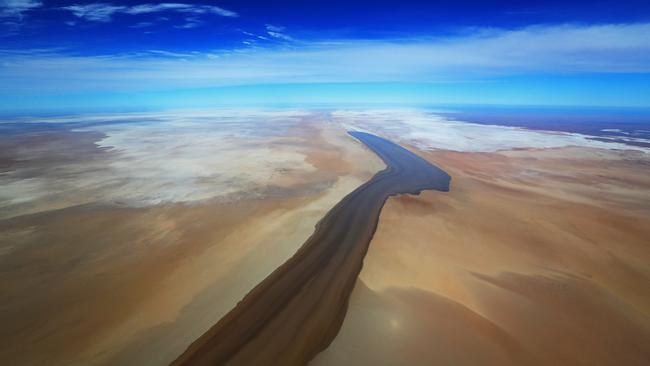 A 1km-wide finger of floodwater reaches Lake Eyre. Picture: Lyndon Mechielsen