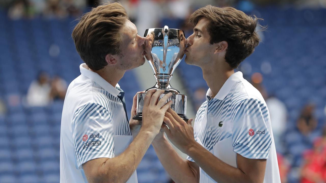 Frenchmen Pierre-Hugues Herbert (right) and Nicolas Mahut won the 2019 Australian Open men’s doubles title but at least one of them won’t be in Melbourne next month. Picture: AAP