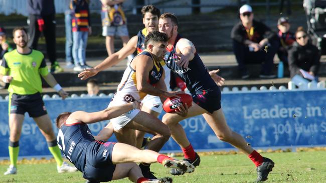 Adelaide's Tyson Stengle tries to bust through a Marc Bower tackle. Picture: AAP Image/Russell Millard