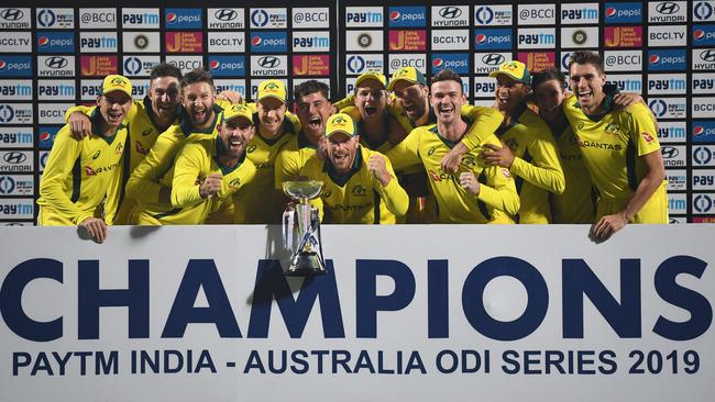 Australia’s cricketers pose with the PAYTM Series trophy. Picture: AFP