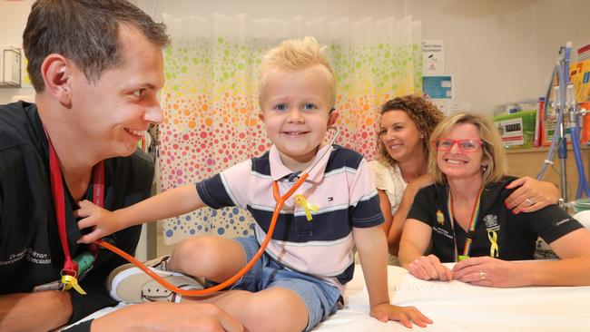 Charlie Shirran 3, playing doctor with his father Dr Mark Shirran, who works in the Emergency Department at the Gold Coast Uni Hospital, his mother Jo Shirran and one of Marks work colleagues, Dr Christa Bell, who diagnosed Charlie with cancer. Picture Glenn Hampson