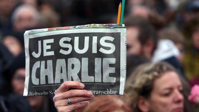 Mourners gather in Berlin for one of many vigils held around the world to honour the 12 killed by gunmen at Charlie Hebdo’s offices.