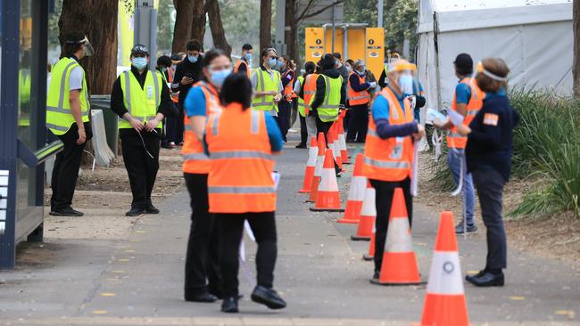 People are seen queued to receive their vaccination at the NSW Vaccine Centre at Homebush Olympic Park in Sydney. Picture: NCA NewsWire/Christian Gilles