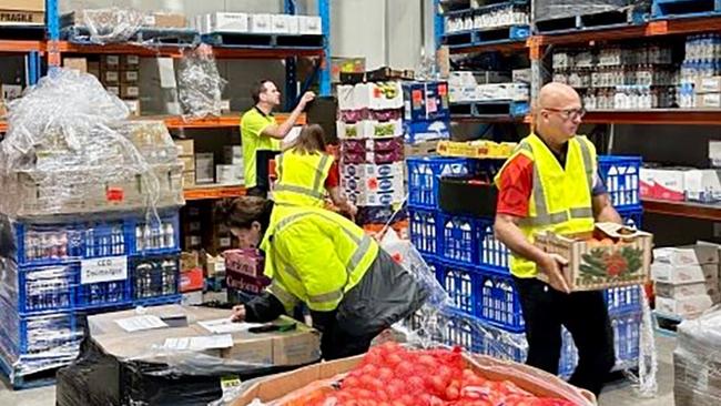 CEQ workers prepare to send stock from its Cairns warehouse to the ABIS supermarket in Kowanyama.