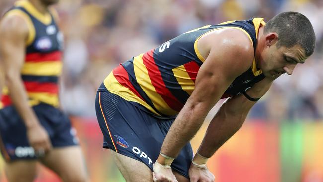 AFL – 23/03/19 – ROUND 1 – Adelaide Crows v Hawthorn at the Adelaide Oval. Eddie Betts in the background with Taylor Walker with his hands on his knees as they go to 3 quarter time. Picture SARAH REED