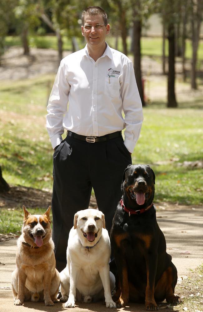 Owner of Jordan Dog Training, Justin Jordan of Albany Creek, with Red the cattle dog, now 8, his late Labrador, Lex, who passed away at 13 and his late rottweiler, Zed, who recently passed away from cancer at 9. Picture: Sarah Marshall