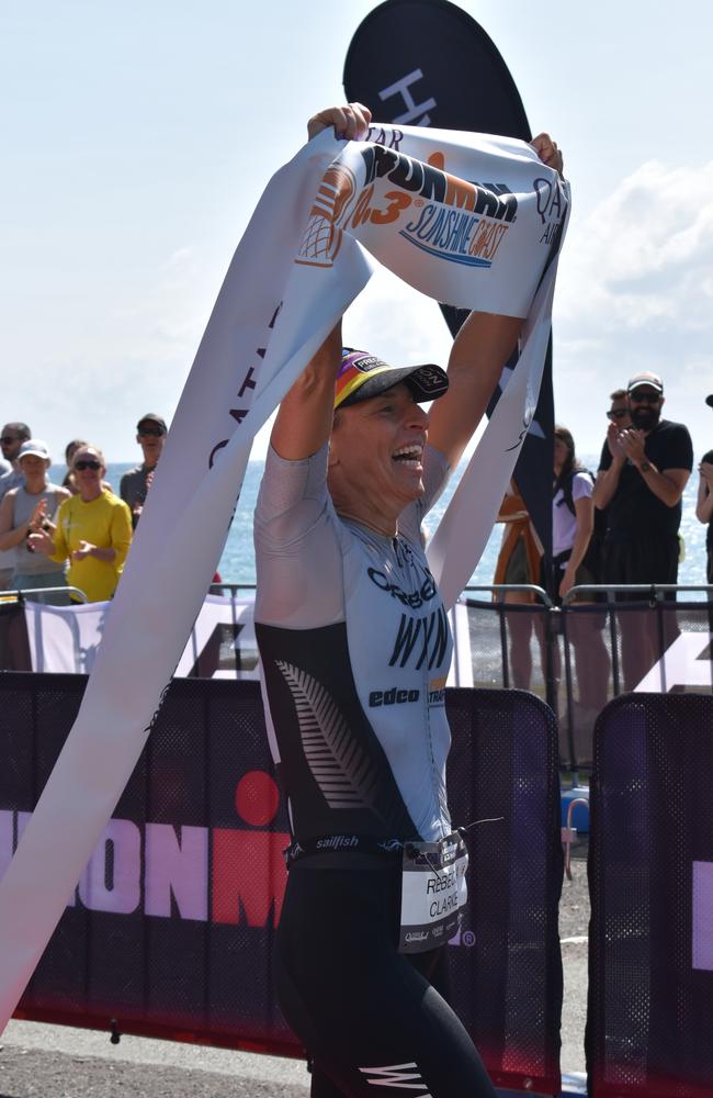 Women's first place: Rebecca Clarke crossing the finish line at the Sunshine Coast Ironman 70.3 2023.