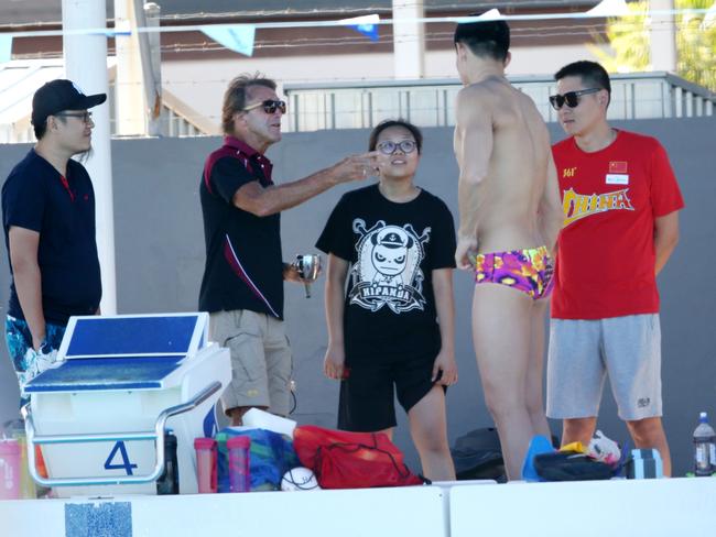 Swim coach Denis Cotterell speaks to Sun Yang at Miami. Picture: Nigel Hallett