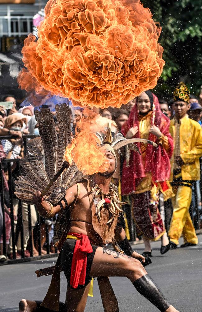 I’m the fire starter: Dancers from the Dayak tribe perform during an arts festival in Surabaya, Indonesia. Picture: Juni Kriswanto/AFP