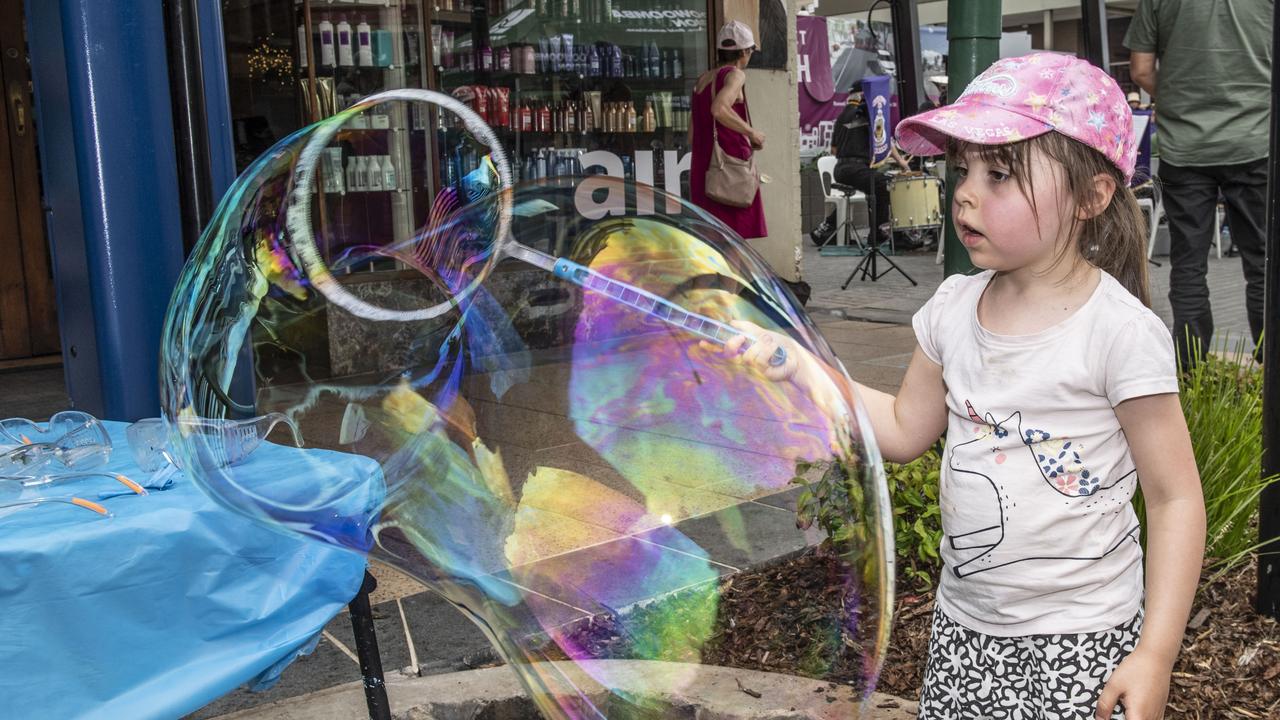 5 year old Amelia Cash makes the best bubbles at the Russell Street Refresh block party. Saturday, November 20, 2021. Picture: Nev Madsen.