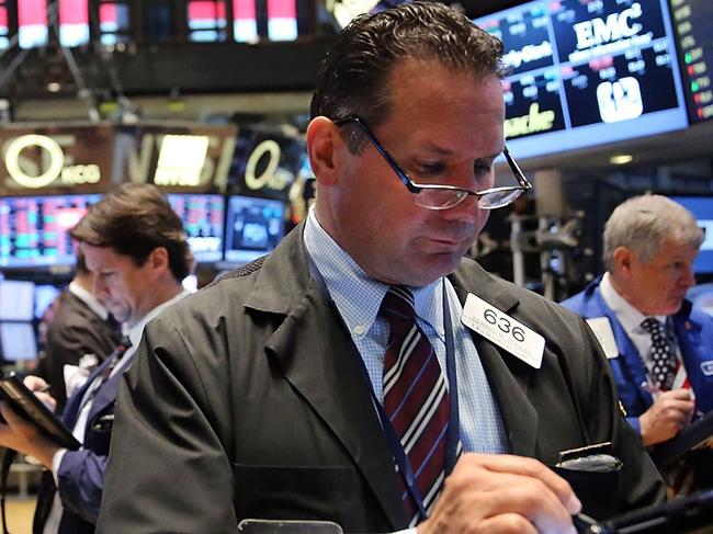 NEW YORK, NY - SEPTEMBER 11: Traders work on the floor of the New York Stock Exchange (NYSE) on September 11, 2015 in New York City. The Dow was down 50 points in morning trading. Throughout the nation people are holding somber gatherings and memorial events to reflect on the 14-year anniversary of the 9/11 attacks that resulted in the loss of nearly 3,000 people. Spencer Platt/Getty Images/AFP == FOR NEWSPAPERS, INTERNET, TELCOS & TELEVISION USE ONLY ==