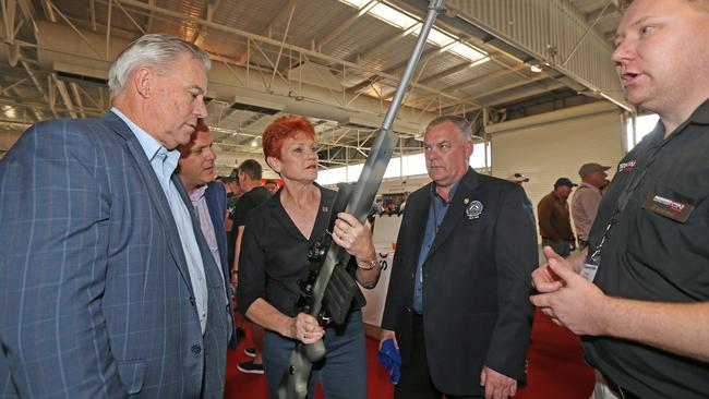 Pauline Hanson is in Perth. AT SSAA Shot Expo at the Claremont Showgrounds. Pictured - Pauline Hanson handles a rifle from Beaton Firearms. With Colin TincknellSen. Peter Georgiou, Ron Bryant (President of Sporting Shooters Ass. of Australia) and Zaine Beaton (gun manufacturer)Picture: Daniel Wilkins