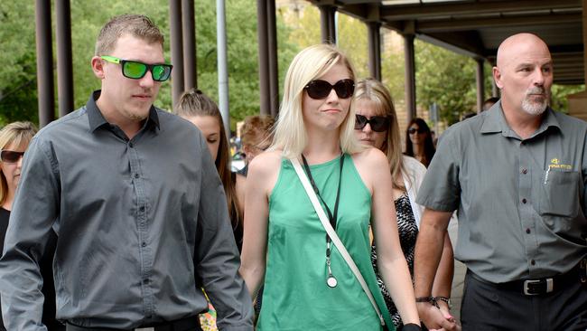 Jason Lindsay leaving the District Court with fiancee Sarah Lake and his father Doug.