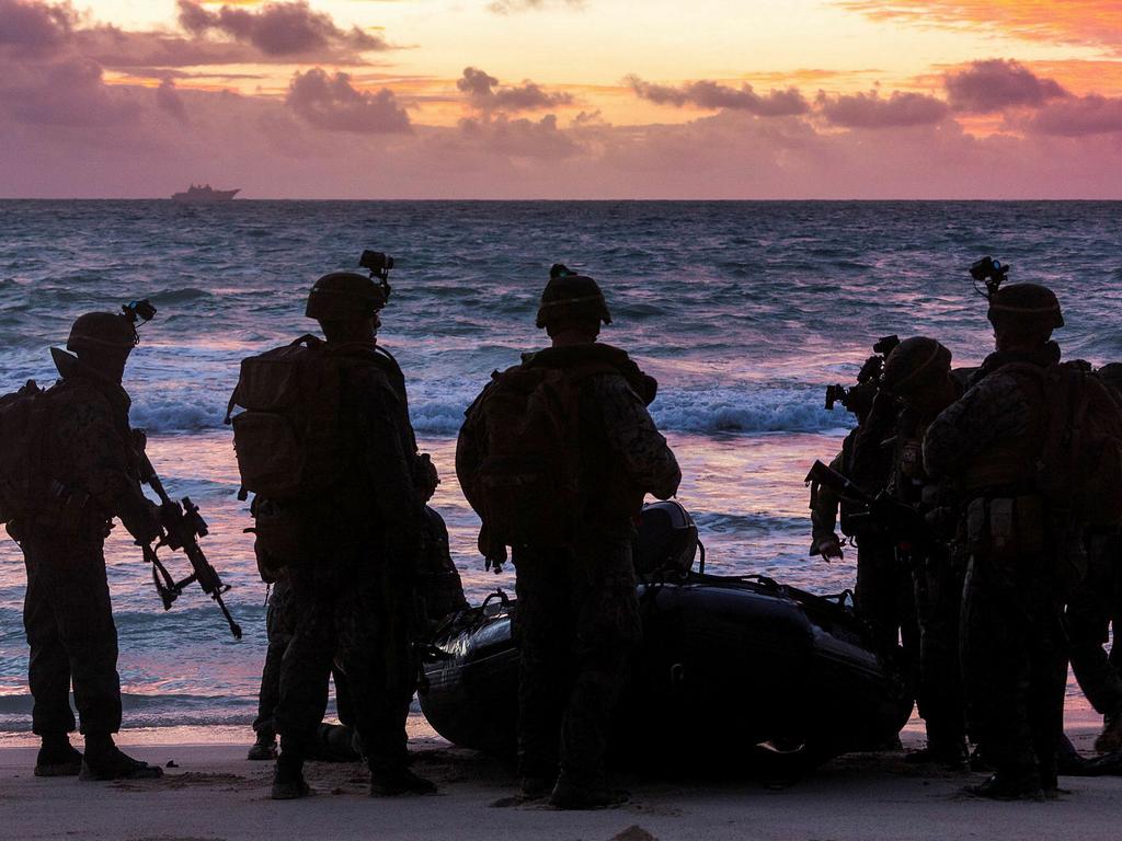 Soldiers from the 2nd Battalion, Royal Australian Regiment and United States Marines during the amphibious assault. HMAS Adelaide is on the horizon. Picture: Defence