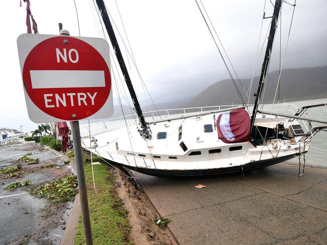 A boat is seen smashed against the bank at Shute Harbour, Airlie Beach. Picture: Dan Peled/AAP