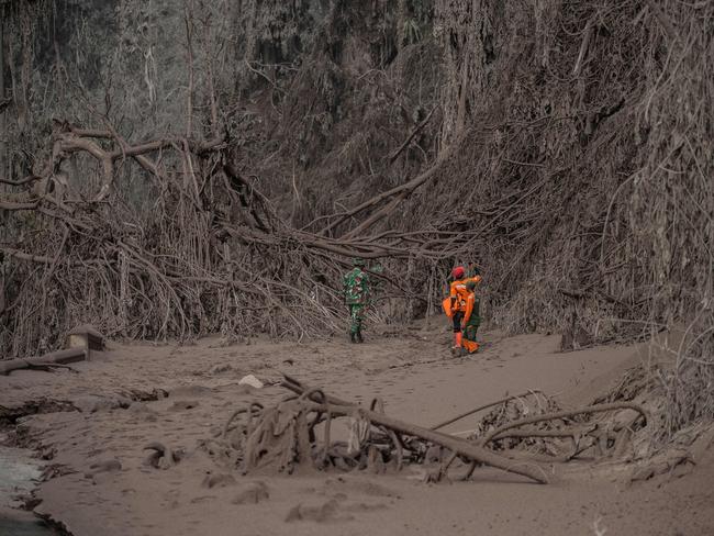 Rescue personnel search for villagers in an area covered in volcanic ash at Sumber Wuluh village in Lumajang after the Semeru volcano eruption. Picture: AFP