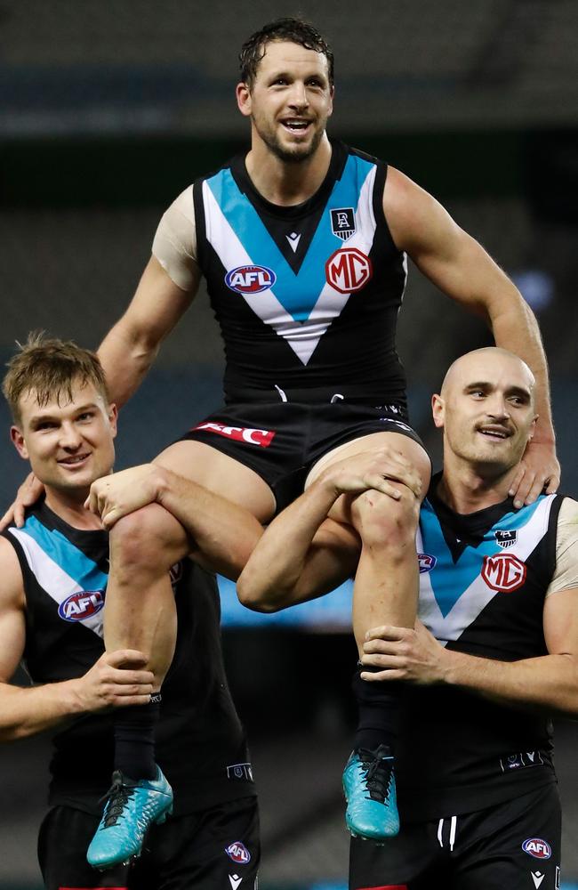 Travis Boak is chaired from the field after his 300th match by teammate Ollie Wines (left) and Sam Powell-Pepper (right). (Photo by Michael Willson/AFL Photos via Getty Images)