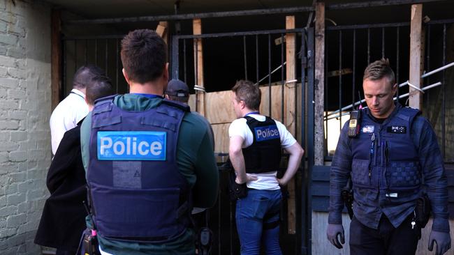 Cops get ready to raid a Frankston squatter den.