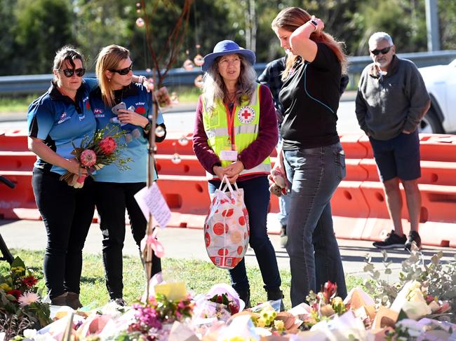 SYDNEY, AUSTRALIA - June 15, 2023: Friends lay flowers at the crash site, in memory of their former opponents and friends who played for the Singleton Roosters. Picture: Jeremy Piper