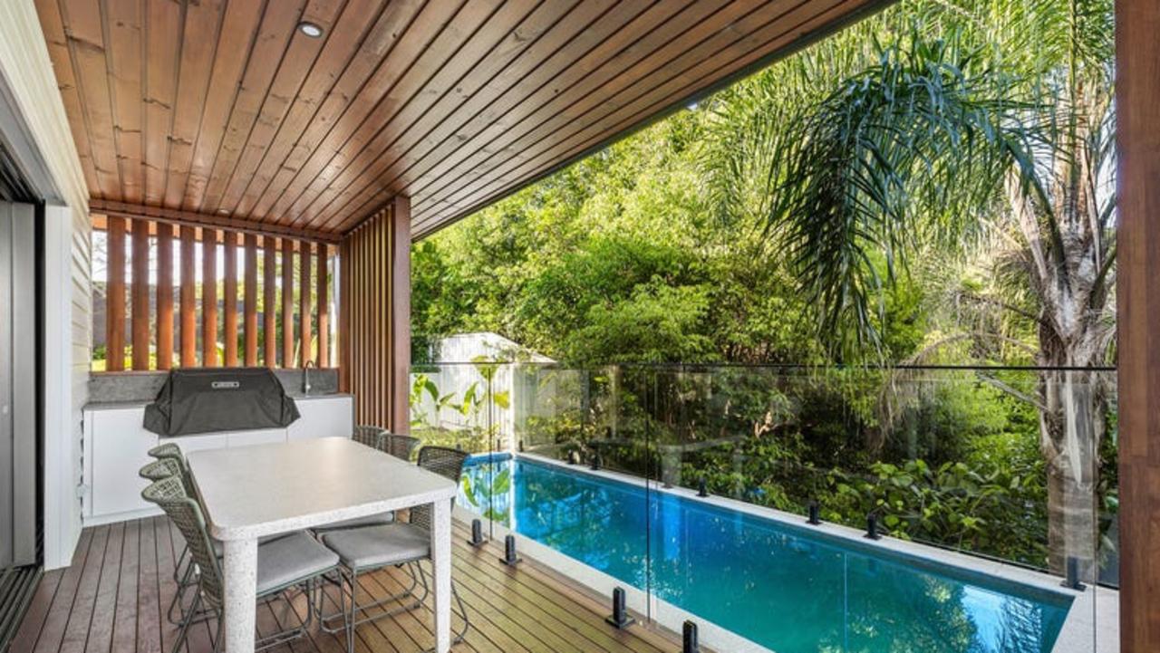 The home has a large deck overlooking a pool