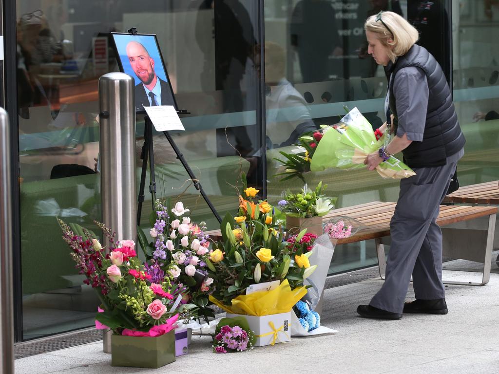 A women places a bouquet at the entrance to Box Hill Hospital in memory of surgeon Patrick Pritzwald-Stegmann. Picture: David Crosling