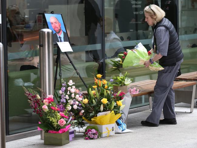 A women places a bouquet at the entrance to Box Hill Hospital in memory of surgeon Patrick Pritzwald-Stegmann. Picture: David Crosling
