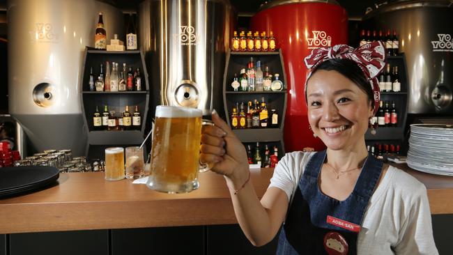 Aoba Haginiwa raises a glass poured from Harajuku Gyoza’s own micro brewery. Picture Glenn Hampson