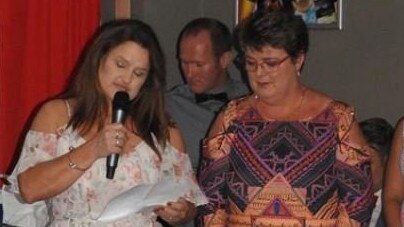 Gabe Watkin receiving her Yeppoon Swans life membership from close friend Rachel Boyd.