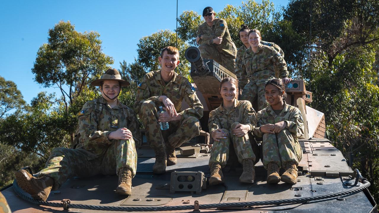 Members of Queensland schools Australian Army Cadets program and a soldier from 2nd/14th Light Horse Regiment (Queensland Mounted Infantry) gather on top of a Boxer Combat Reconnaissance Vehicle.