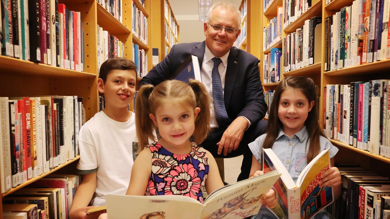 Prime Minister Scott Morrison helps Tom Panozzo, 9, Lily Maher, 7, and Charlotte Maher, 9, practice their words ahead of the Spelling Bee. Picture: Adam Taylor