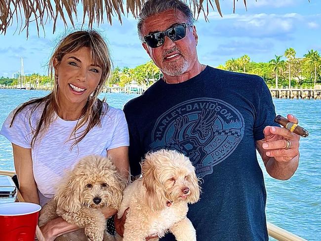 Stallone and Flavin with two of their family dogs.