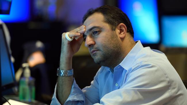 A trader on the floor of the New York Stock Exchange reads from his monitor August 24, 2015 in New York. US stocks finished sharply lower Monday, but far above the session's floor, following a bruising day in global financial markets sparked by mounting worries over the Chinese economy. US stocks have now dropped five straight days, but analysts warned of more turmoil possibly ahead. AFP PHOTO/DON EMMERT