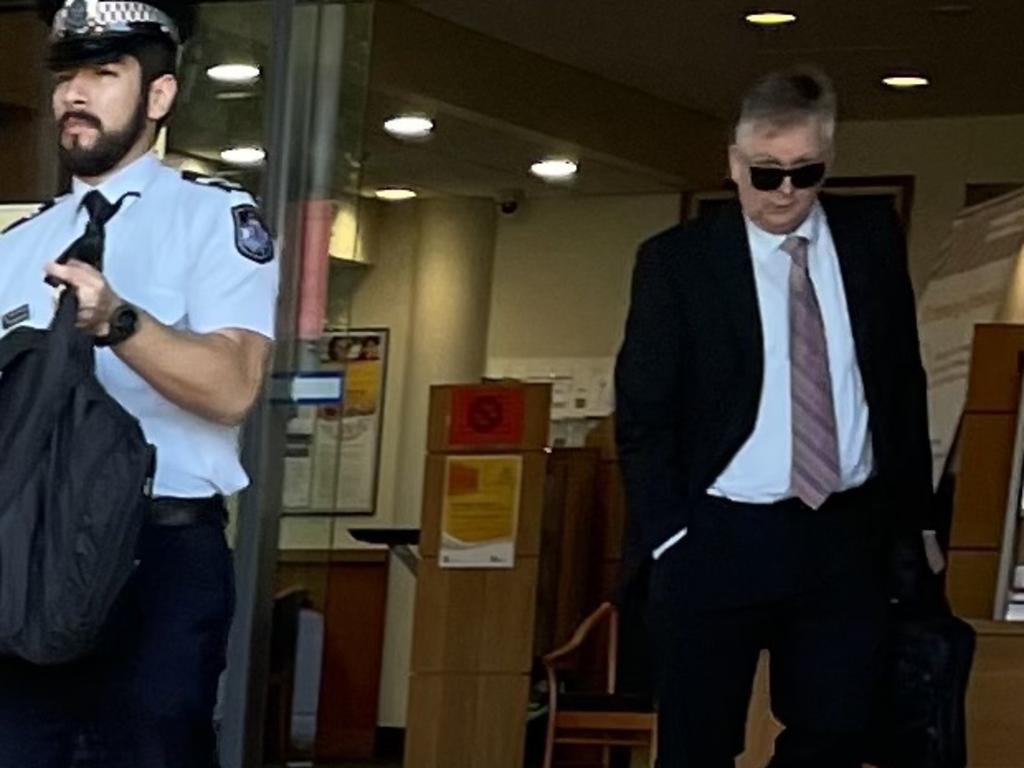 Queensland Police Service Senior Constable Renzo Martinez and Ethical Standards Command Detective Sergeant Neil Parker leave court after giving evidence at an inquest into a death in custody incident where a man died enroute to Rockhampton watch house in November 2019 after being arrested and restrained in the Leichhardt Hotel car park, on Bolsover Street, across the road from the police station and watch house.