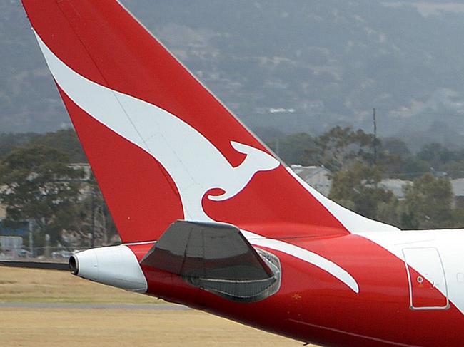 (FILES) This picture taken on December 10, 2013 shows a Qantas flight landing at the Adelaide airport in Adelaide. Struggling Australian airline Qantas will make dozens of pilots redundant for the first time in 40 years, reports said on May 14, 2014, as it looks to slash costs to contain massive losses. AFP PHOTO / FILES /Saeed KHAN