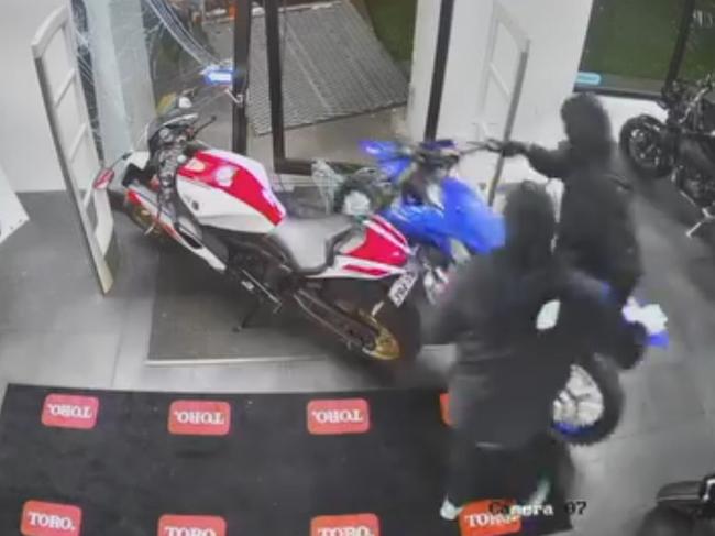 Watch: Masked bandits smash through showroom, steal motorbikes