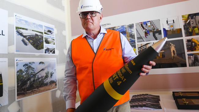 Scott Morrison with an ammunition shell during a visit to Rheinmetall NIOA Munition factory in Maryborough, Queensland. Picture: AAP