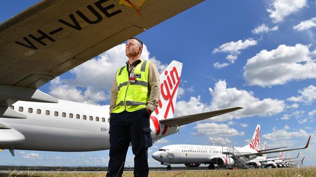 Airside operations team leader Chris McCullen with grounded Virgin Australia aircraft at Brisbane Airport Picture: AAP