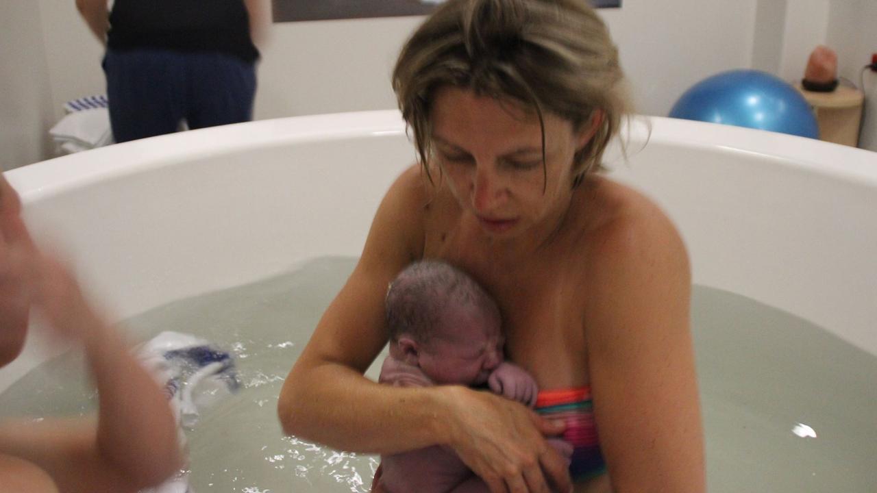 Mackay surrogate mum Hayley Wilson in the birthing pool with the newborn baby she had nourished through pregnancy for another couple. Picture: Contributed